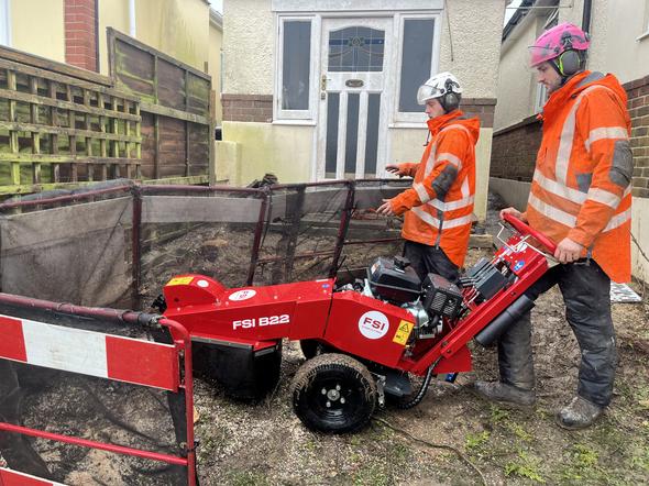 Tree Stump Removal in Weymouth, Dorchester, Portland, Dorset. Weymouth tree surgeon team wearing a hi-vis jacket and helmet to carry out a removal of a stump with a stump grinder in Weymouth, Dorset